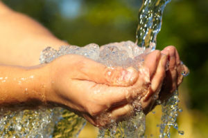 woman's hands overflowing with water