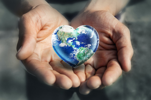 God's Hands Holding the Future - heart shaped globe